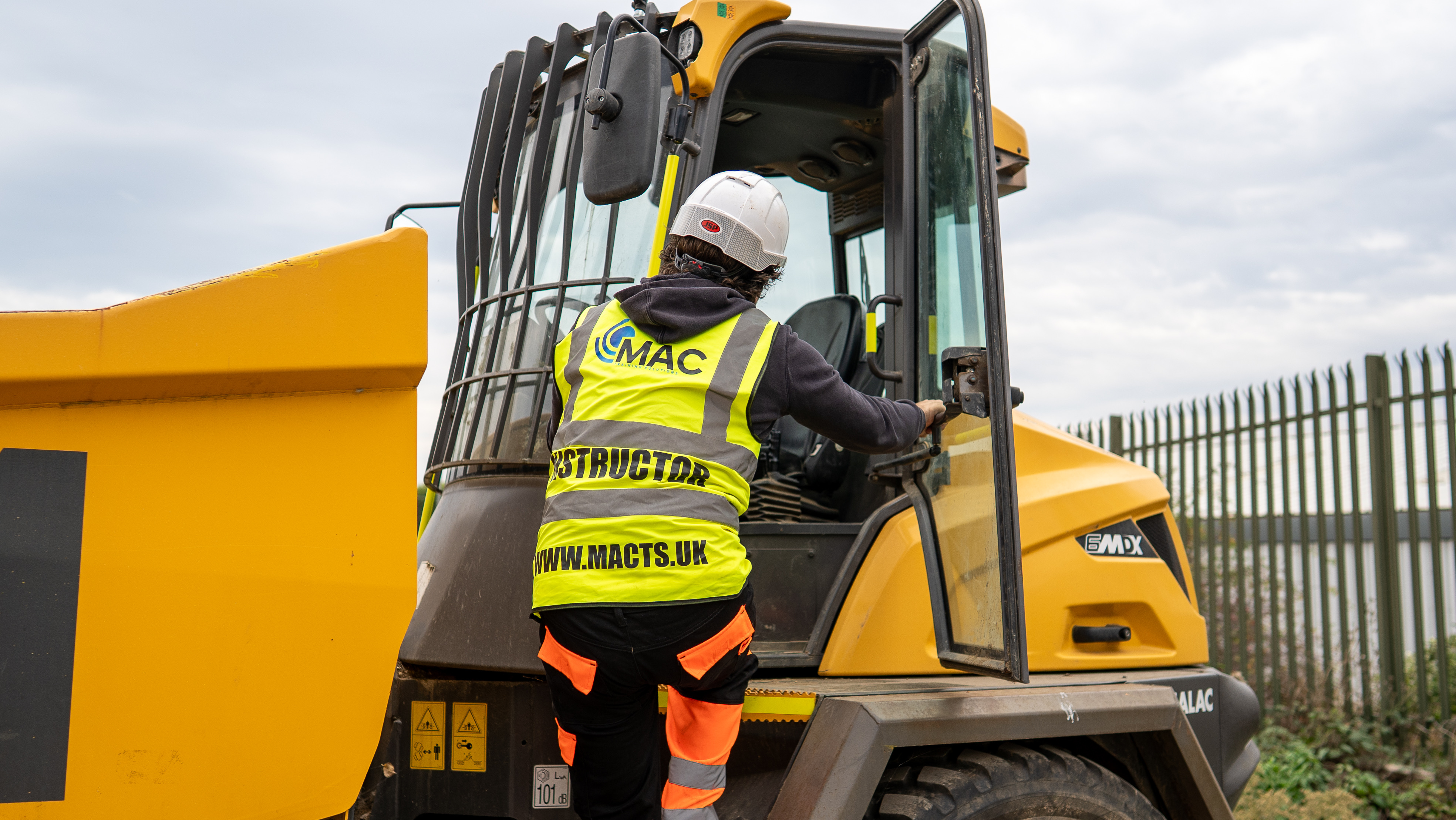 MAC instructor climbing into a site dumper on a training site