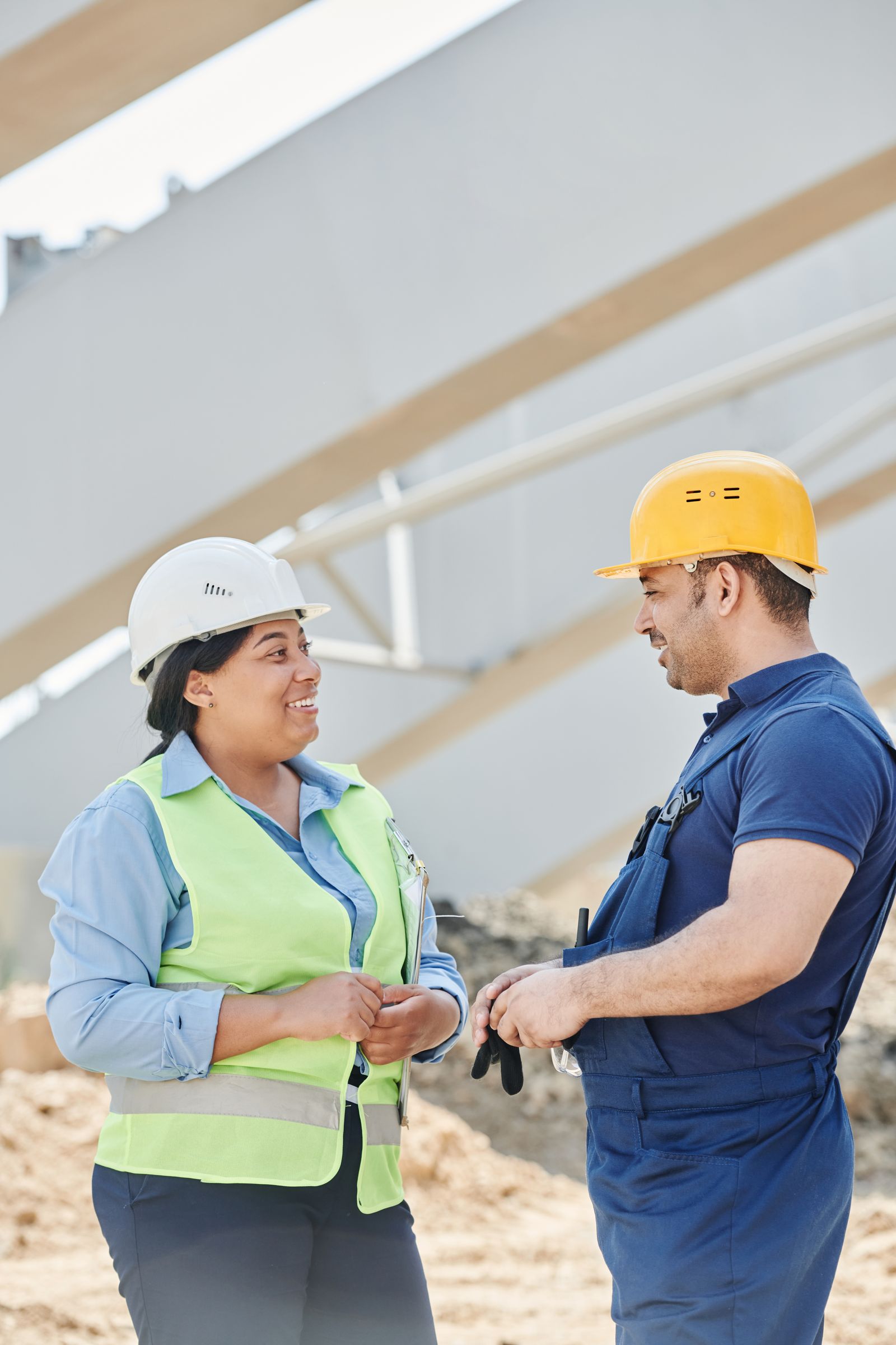 Construction supervisor and operator discussing site training